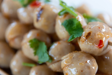 Grilled meatballs topped with spicy sweet sauce and sprinkle the coriander leaves.