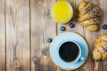 Breakfast served with croissants, coffee, orange juice and berries.