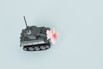 war machine with a flower in the back, peace and war, military action, a flower in the barrel of a tank, a concept on the army, free space, copy space, space for text, victory day, may 9, world war