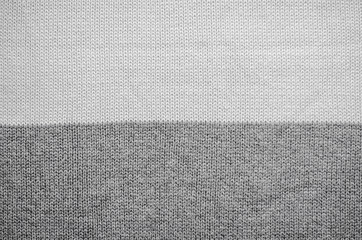 White knitted fabric background. The texture of the white wool fabric. 