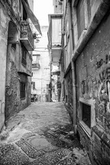 Fototapeta na wymiar Naples, Italy - August 09, 2015 : Narrow streets of Naples, black and white photographs.