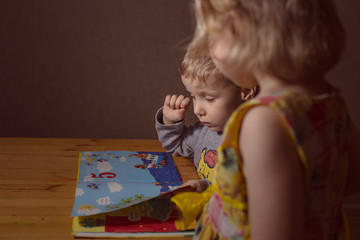 small children learn to read a book