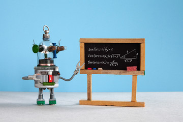 Artificial intelligence and trigonometry lesson in college. Robot teacher explains theory inverse trigonometric functions. Classroom interior with handwritten formula black chalkboard. Blue gray - obrazy, fototapety, plakaty