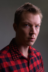 Face of young handsome hipster man with shadows