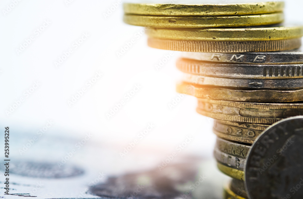 Poster closeup of gold and silver coins stacking in each different position on white background - image.