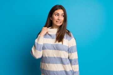 Fototapeta premium Young woman over blue wall with tired and sick expression