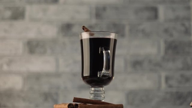 Mulled wine in a beautiful glass. Winter warming drink. Glass of mulled wine with spices. 