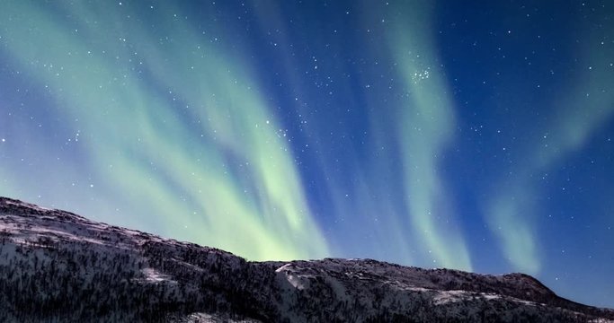 Northern Lights, polar light or Aurora Borealis in the night sky over Senja island in Northern Norway time lapse.