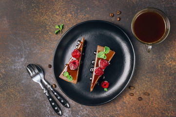 chocolate or coffee cheesecake with glaze, mint and raspberry