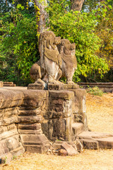 Fototapeta na wymiar Preah Ko temple, Cambodia: Khmer style guardian lions sculptures