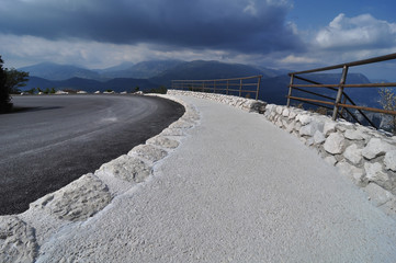 pantone classic blue winding mountain road in verdon canyon cote azur in front of dramatic blue sky and clouds