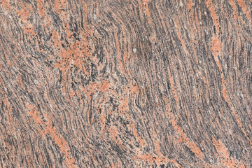 Pink orange black Indian flat granite texture background