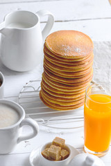 Close up of tall pancakes stack. Concept of tasty breakfast.