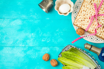 Jewish holiday Passover background with matzo, seder plate and wine on wooden table.