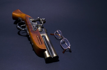 fake antique pistol and glasses