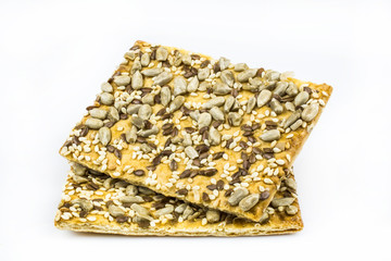 Two cookies with the content of cereals isolated on a white background.