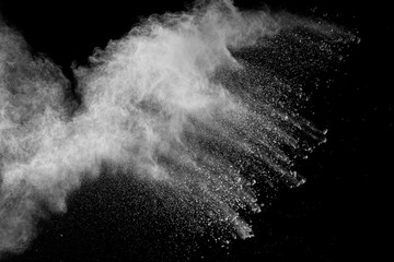 Fototapeta na wymiar White powder explosion isolated on black background. White dust particles splash.Color Holi Festival.