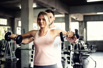 Naklejka na ściany i meble Portrait Fitness coaches are controlling the training equipment of lovers, Helps create motivation for exercise,fitness concept 