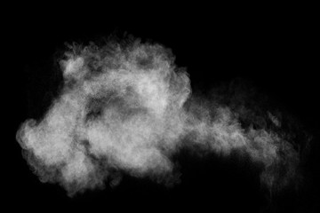 White powder explosion isolated on black background. White dust particles splash.Color Holi Festival.