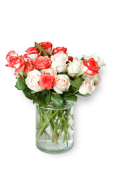 a bouquet of multi-colored roses stands in a glass vase on a white table in the kitchen