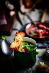 Brussels sprouts soup with bacon.dark photo