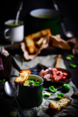 Brussels sprouts soup with bacon.dark photo
