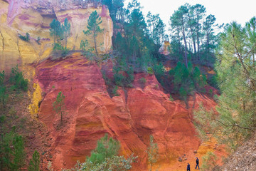 Editorial illustrative. Roussillon Provence France. February 9, 2019. Tourists on the hiking trail in the ocher canyon. Winter tourism.