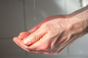 Fototapeta premium correct hands disinfection with disinfectant and water