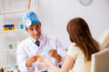 Young woman visting male doctor otolaryngologist