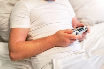 man with a beard playing a game console, copy space