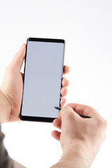 Smartphone with touch pen in hand
