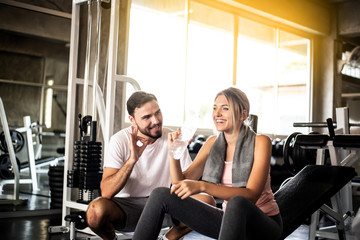 Portrait Fitness coaches are controlling the training equipment,Dumbbell Triceps Extension The Triceps are powerful,beautiful young girl warming up with weights in Gym health club