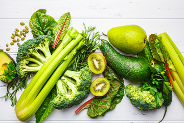 Green food background. Healthy green vegetables and fruits, top view.