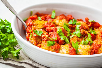 Baked vegan bean meatballs in tomato sauce.