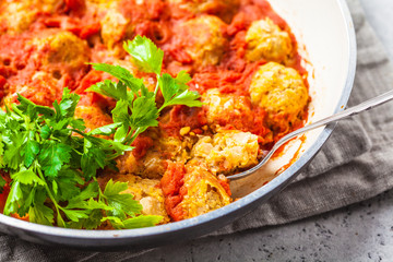 Baked vegan bean meatballs in tomato sauce in the pan.
