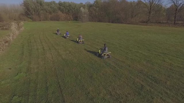 drone orbit over speeding quad bikes