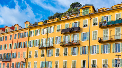 Nice, France, beautiful houses built on hillside, on the marina, with typical windows and shutters 