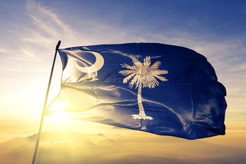 South Carolina state of United States flag waving on the top sunrise mist fog