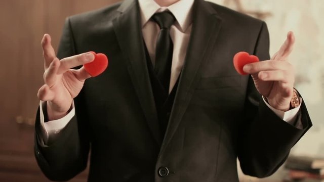 Young illusionist performing tricks with paralon heart