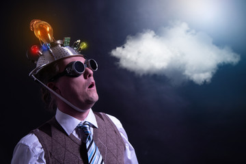 distraught looking conspiracy believer in suit with aluminum foil head with chemtrails cloud...