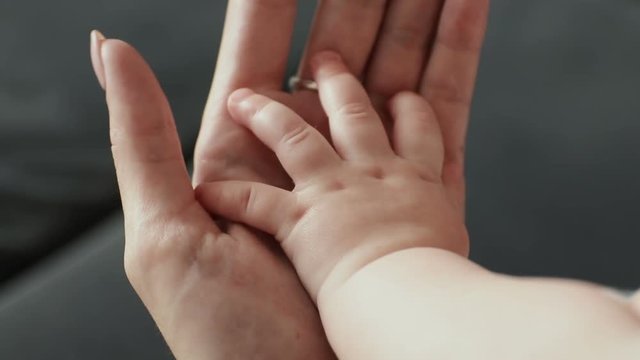 Parent holding babys hand. Newborn baby hand in mother hand