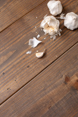 Garlic Bulb and Cloves on a Wooden Table; One Isolated in Front