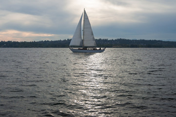 A yacht sailing in Marina Bay at sunsent, Kirkland, WA, USA