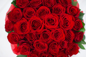 bouquet of red roses in a white box on a white background pattern