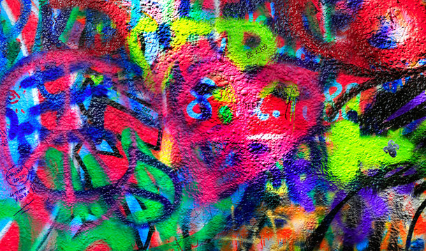 Detail of bright colorful John Lennon's wall with graffiti in Prague