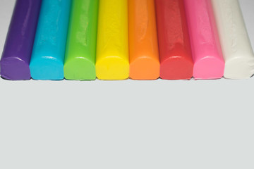 Colorful clay sticks in a row background, DIY arts