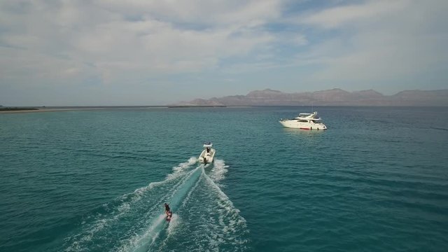 Aerial drone shot of a person skiing in a Island iof the Sea of Cortez