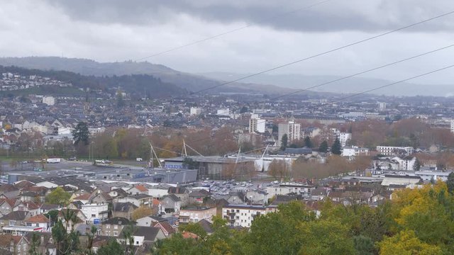 A close up view of Brive la gaillarde from the hills of Malemort with rain threats in the background