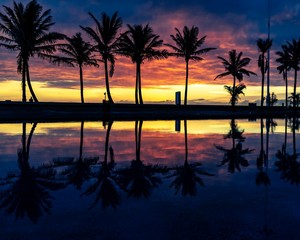 Fototapeta na wymiar Sunrise at beach with reflections in pool