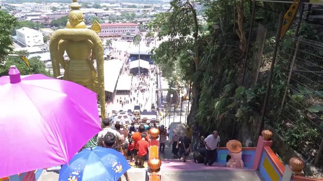 Tourist walking up and dow the steps of batu caves in malaysia  